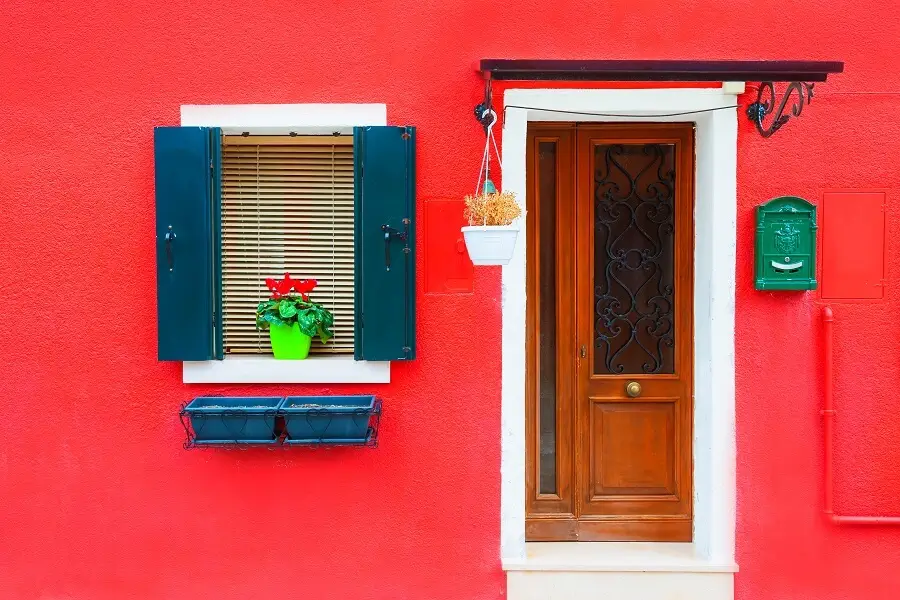 Home exterior with a modern design, vibrant red walls