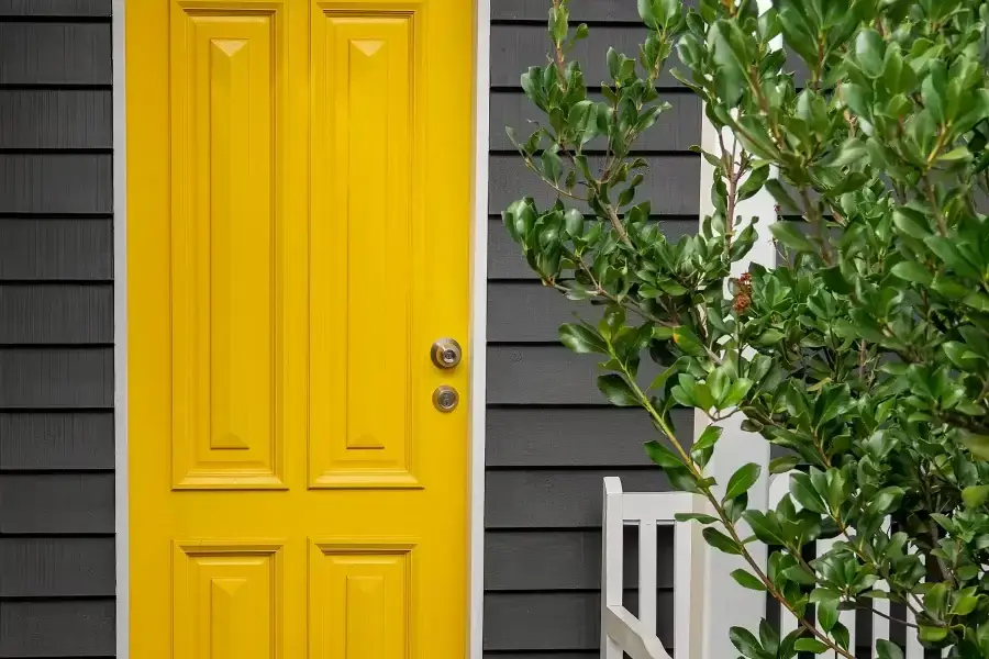 Exterior of a home with door painted in yellow