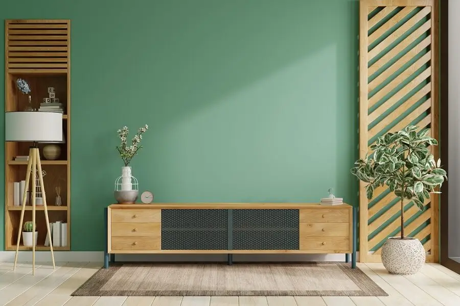 Modern living room with a bold teal accent wall