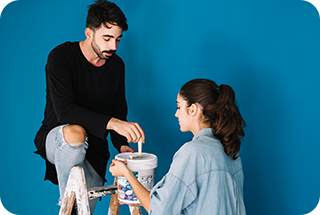 A man and woman painting the wall